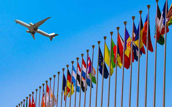 Flags of the world with aeroplane flying overhead