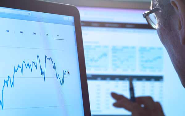 Man viewing data and charts on screen